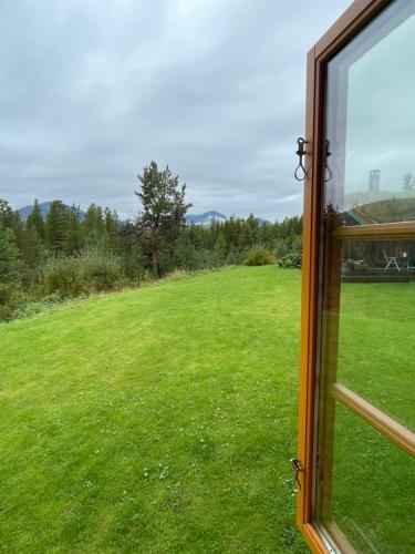 a view of a field from a window at Rondane Sollia Friluftsliv Øvre Nordli in Sollia