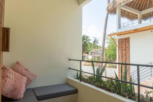 a balcony with a bench and a view at Aymara Punta Zicatela in Brisas de Zicatela