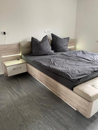 a bedroom with a large bed with a wooden frame at Ferienwohnung im Spessart-Steinbach in Lohr