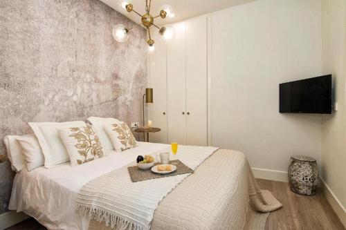 a bedroom with a bed with a tray of food on it at Terrace Suite City Center in Granada