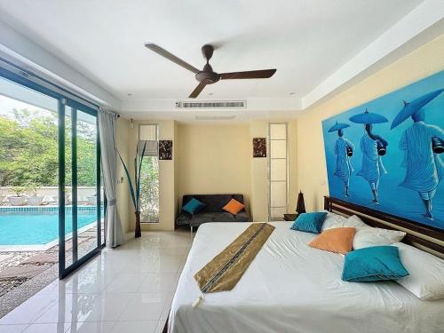 a bedroom with a bed and a ceiling fan at villa lavanya in Bophut 