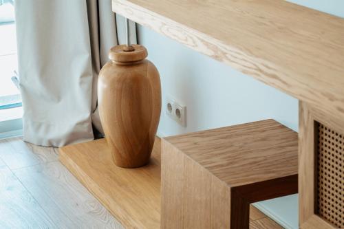a wooden vase sitting on top of a wooden table at Green Cape Botanico in Batumi