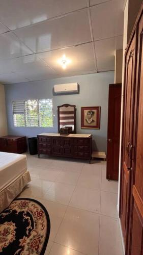 a room with a bed and a dresser and a mirror at Apto close to more than 19 tourist attractions in La Entrada