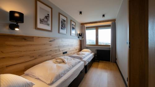 A bed or beds in a room at Bukowa 21, Sun & Snow