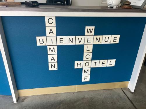 a blue sign with a cross on top of it at Hotel Caiman in Pierrelatte