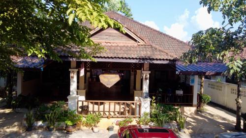 a house with a sign on the front of it at Cousin Resort in Khao Lak