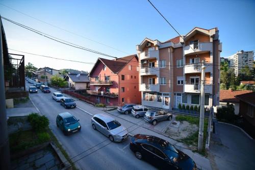 a city street with cars parked on the street at Apartman Palermo in Užice