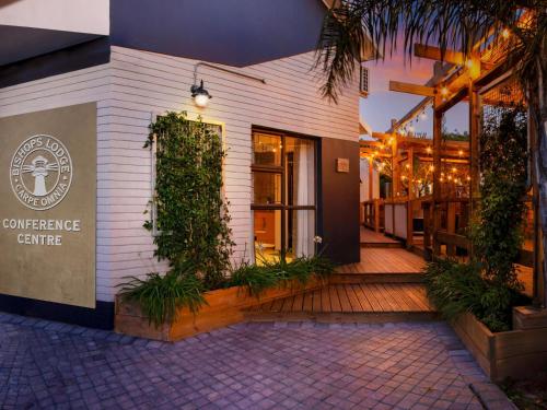 a building with a patio with plants on it at Bishops Lodge in Gqeberha