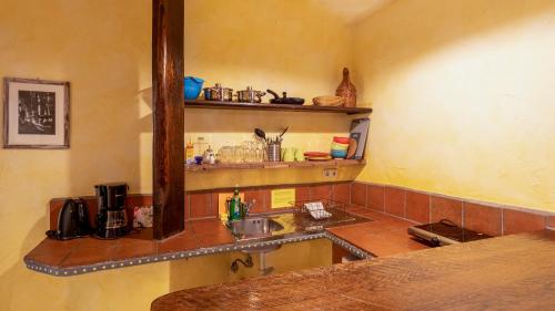 a kitchen with a sink and a counter with a mirror at Gästehaus Mezcalero in Dresden