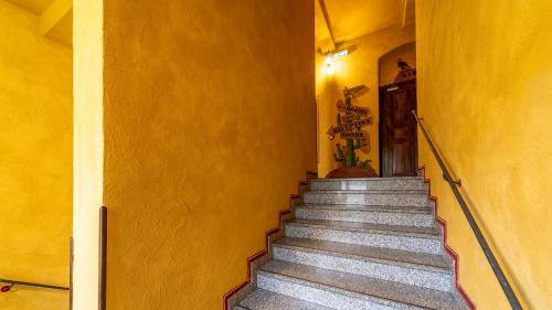 a set of stairs in a yellow building at Gästehaus Mezcalero in Dresden