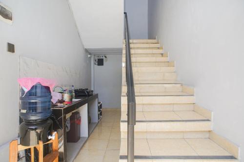 a set of stairs in a room with a kitchen at Fun Living Guest House in Seminyak