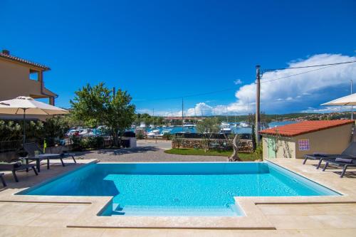 a swimming pool with a view of a marina at Villa Marin in Klimno