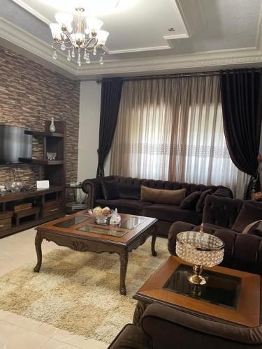 a living room with a couch and a coffee table at Shafa Badran Villa in Amman