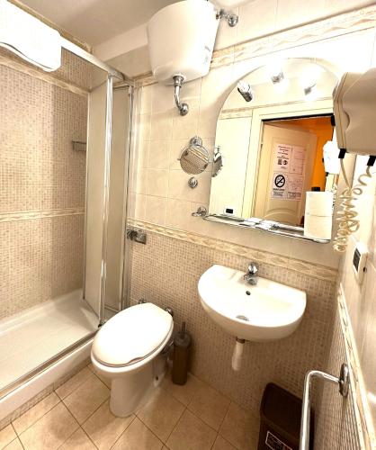a bathroom with a toilet and a sink and a shower at Sun Moon in Rome
