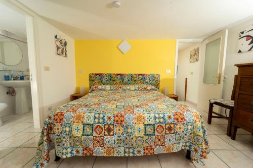 una camera da letto con un letto con un copriletto colorato di Un angolo di paradiso nel centro di Anacapri ad Anacapri