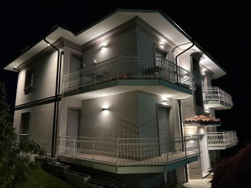 a large white building with a balcony at night at Villa Sofia in Baveno