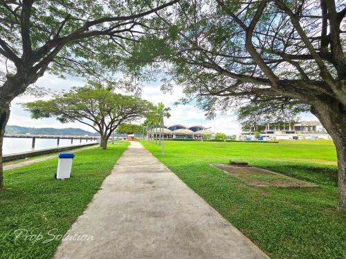 a walking path in a park next to a body of water at Loft Suite Johor Bahru Legoland 6Pax in Iskandar Puteri