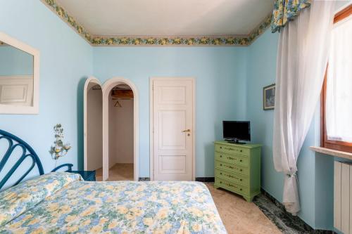 a bedroom with blue walls and a bed and a window at Hotel Sonia in Forte dei Marmi