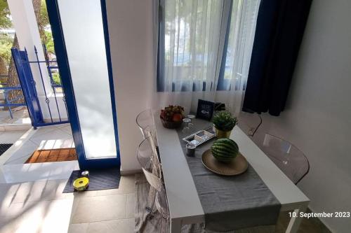 a room with a table with a cactus on it at Poseidons Retreat optional el car and airporttrans in Sounio