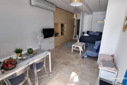 a living room with a table and a couch at Poseidons Retreat optional el car and airporttrans in Sounio