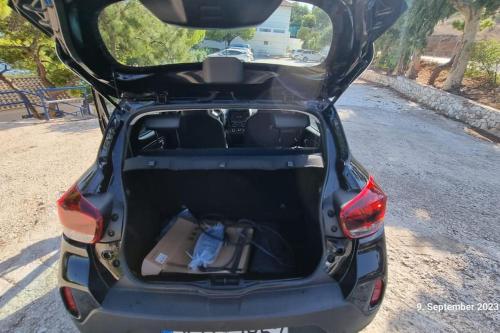 a car with its trunk open on a road at Poseidons Retreat optional el car and airporttrans in Sounio