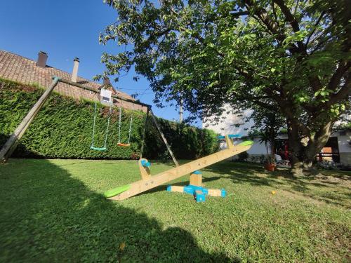 a wooden swing set in a yard at La Clef des Champs - Proche Colmar in Biesheim