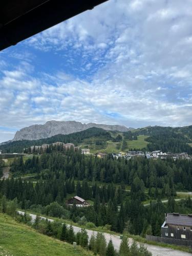 a view of a valley with trees and mountains at Sonnenalpe Nassfeld in 1500 m Höhe an der Skipiste in Sonnenalpe Nassfeld