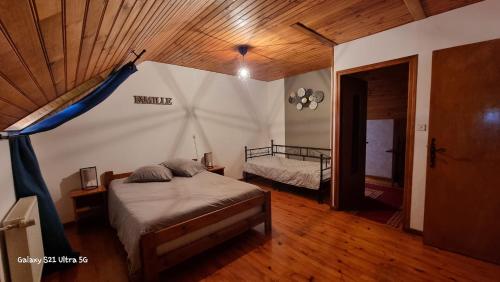 a bedroom with a bed in a room at Les Chambres du Saladou in Mont-Chanson