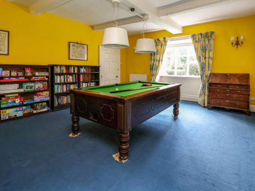 a billiard table in a room with yellow walls at New Hall in Wrexham