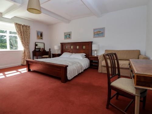 a bedroom with a bed and a desk and a couch at New Hall in Wrexham