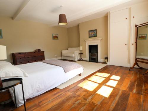 a bedroom with a bed and a chair in it at New Hall in Wrexham