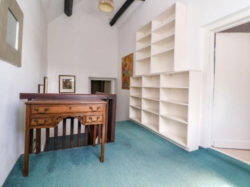 a desk in a room with shelves at New Hall in Wrexham