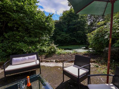 two chairs and an umbrella on a patio at New Hall in Wrexham