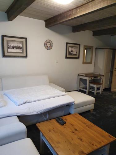 a room with two beds and a wooden table at Apartmán Anička in Tatranská Lomnica