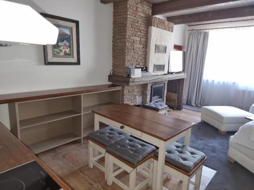 a living room with a table and a fireplace at Apartmán Anička in Tatranská Lomnica