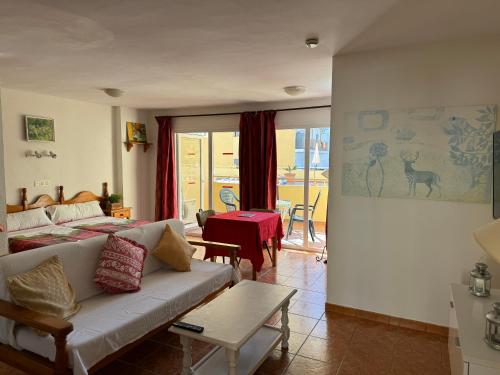 a living room with a couch and a table at Apartamentos Turísticos Yamasol in Fuengirola