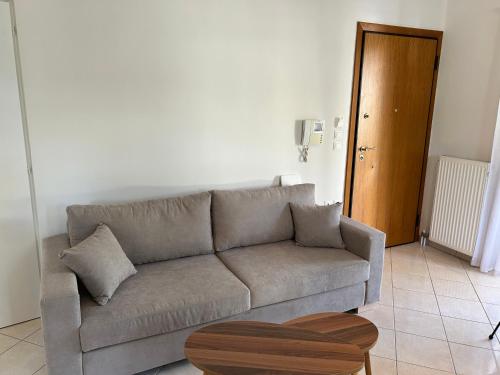 a living room with a couch and a table at Mesogaia Home Near ATH Airport in Markopoulo