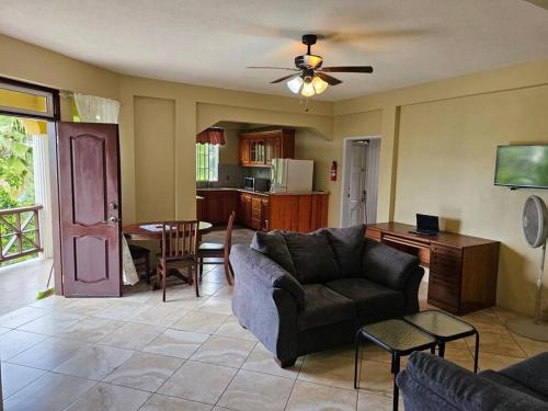 a living room with a couch and a table at Sleek 1-Bedroom Apt #1 - 5 Mins to SGU in True Blue