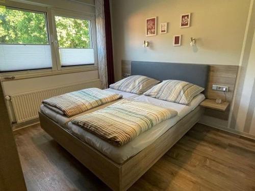 a bed in a room with two pillows on it at Ferienhaus Geers am Klostersee Dargun in Dargun