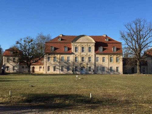 a large building with a grass field in front of it at "Marion s gute Stube" unweit vom Kummerower See in Kummerow