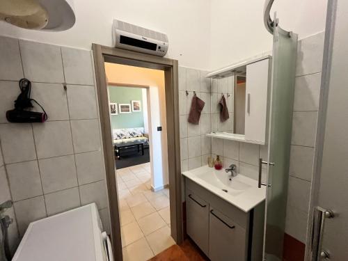 a bathroom with a toilet and a sink and a mirror at The Lovely Loft in Cres