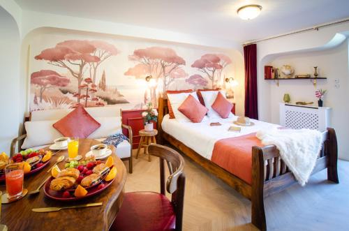 a bedroom with a bed and a table with food on it at Retro Reverie, avec parking gratuit et terrasse in Ban-Saint-Martin