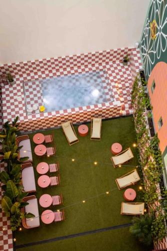 an overhead view of a pool with chairs and a lawn at Upon Angels - Adults Only in Lisbon
