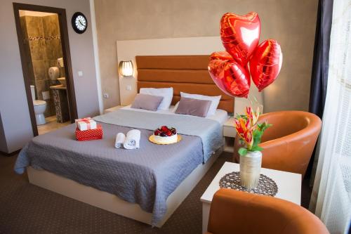 a hotel room with two beds and red balloons at MBI Travel Inn in Craiova