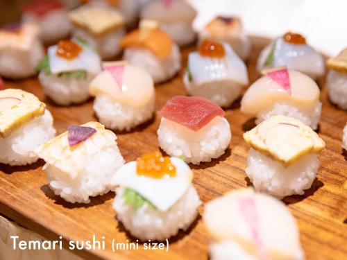 a bunch of sushi on a wooden cutting board at Hotel Naturwald Furano in Furano