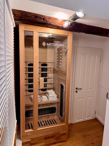 a glass display cabinet in a room next to a door at Celle Old Town Hideaway in Celle