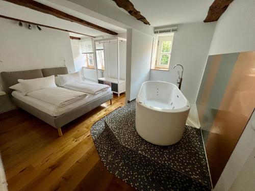 a room with a bath tub and a couch at Celle Old Town Hideaway in Celle