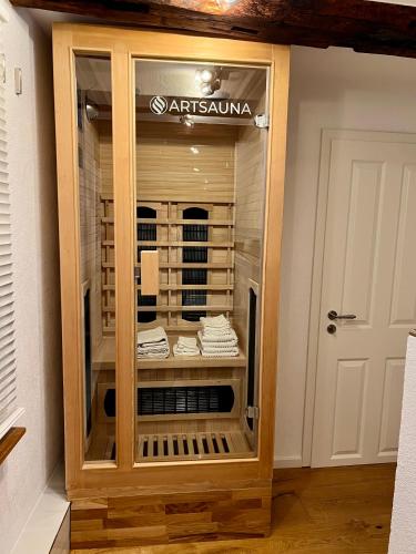 a wooden display case in a room with a door at Celle Old Town Hideaway in Celle