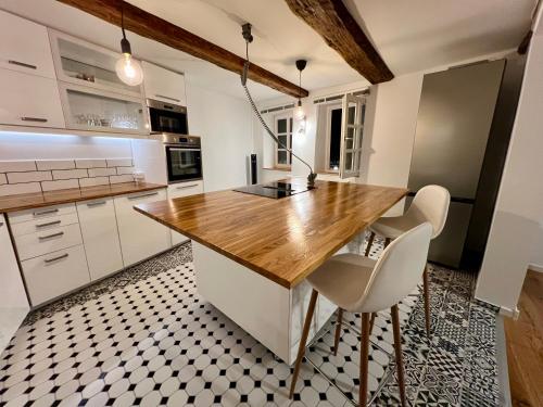a kitchen with white cabinets and a wooden counter top at Celle Old Town Hideaway in Celle
