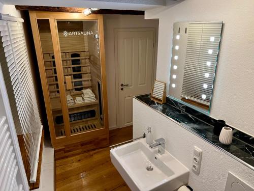 a bathroom with a sink and a medicine cabinet at Celle Old Town Hideaway in Celle